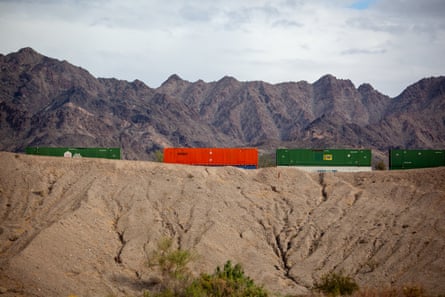 Freight trains against a mountain backdrop