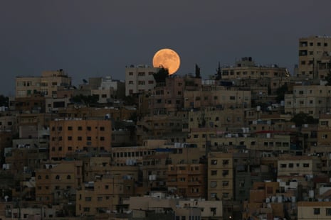 The moon hovers above the city of Amman, Jordan.