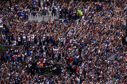 people cheer during a parade