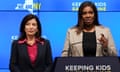 White woman in dark blazer and pink colored shirt next to Black woman in beige blazer and Black shirt who is speaking at a lectern with a sign that says Keeping Kids Safe Online.