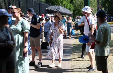 Spectators queue in the shade outside Wimbledon
