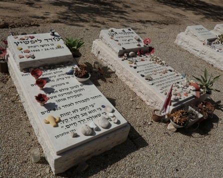 The graves of Oded Lifshitz and Alex (Alexander) Dancyg covered with tribute stones and flowers