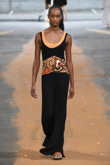 A model with her hair in a ponytail in a sleeveless long dress on the Gabriela Hearst spring 2023 runway