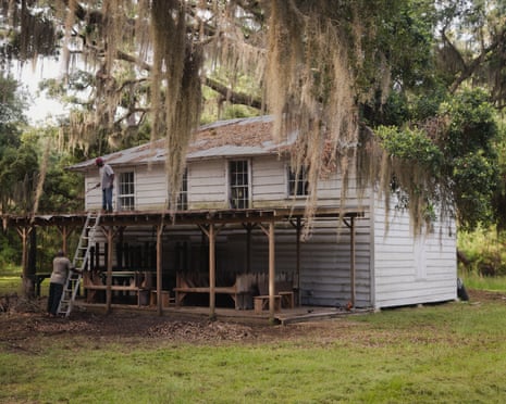 House with wood pergola, ladder and worker on roof