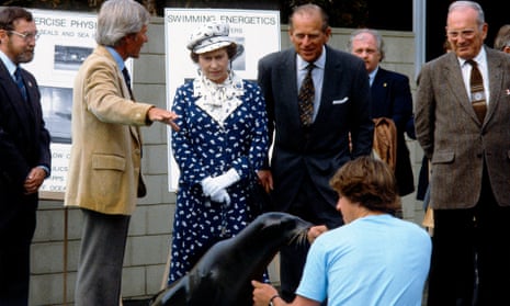 The queen and the Duke of Edinburgh watch a sea lion  being fed at the Institution of Oceanography in San Diego during their trip to California in 1983