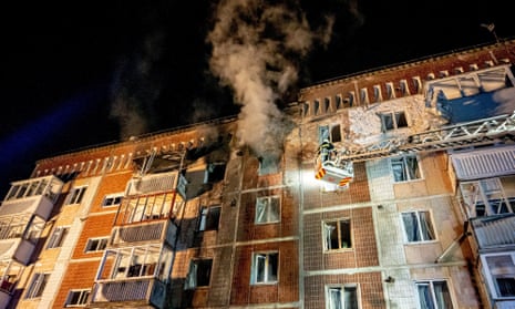 A firefighter works at the site of an apartment building hit by a Russian drone strike in Ternopil.