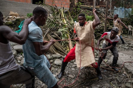 A group of men play a game with red and white rope
