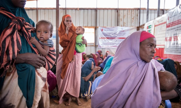Mothers wait with their children at a clinic in Somalia.