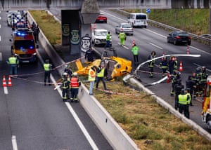 Madrid, Spain: emergency workers stand next to a helicopter that crashed on motorway