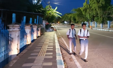 High school students walking to school early in the morning in Kupang, Indonesia.