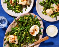 Plates laid out on a table with a blue tablecloth, with the mozzarella and green bean salad on top