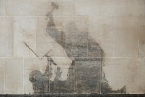 The faded outline of the mural on the wall