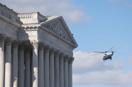 A helicopter circles the US Capitol building