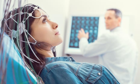 Close up of young woman getting brain analyzed by electroencephalograph