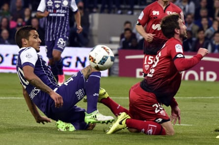 Toulouse midfielder Oscar Trejo gets stuck in against Dijon.