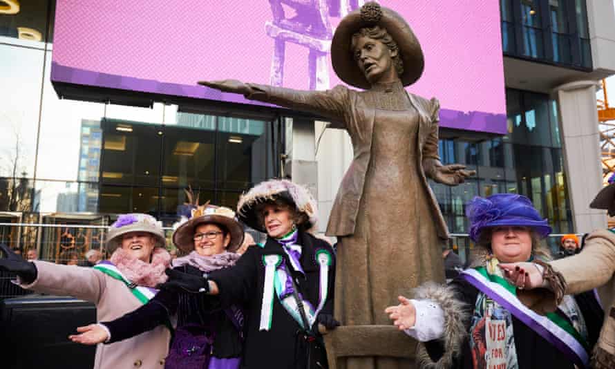 Women dressed as suffragettes pose with Our Emmeline.