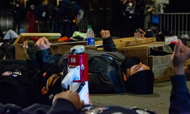 Climate activists stage a die-in near Chicago mayor Lori Lightfoot’s home to protest a metal recycling plant on the Southeast Side on Thursday.