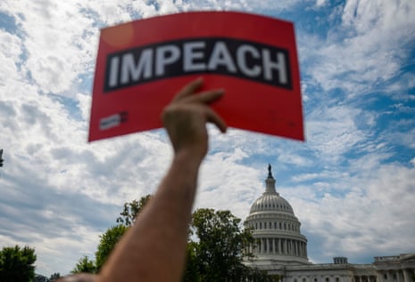 Protesters hold up letters reading ‘impeach’ in front of the US Capitol building during the People’s Rally for Impeachment on Capitol Hill on Thursday.