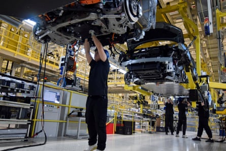 workers build Zeekr cars at a plant in China