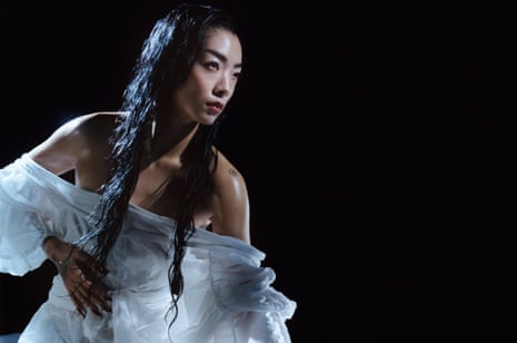 Rina Sawayama poses in a white dress