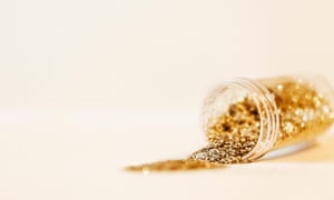 Gold glitter spilling out of a tube