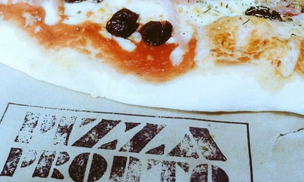 Close up of a pizza and logo napkin from Pizza Pronto, Cardiff