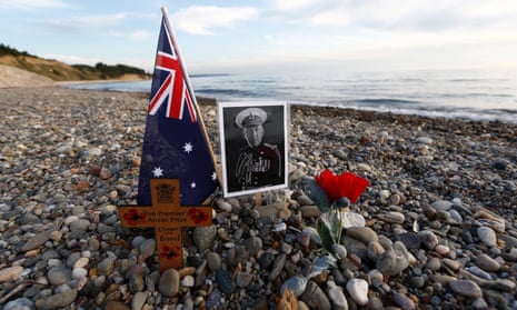 A cross and a picture of an Australian soldier who fought in the Gallipoli Campaign, are seen left by visitors near the Ariburnu Memorial at Anzac Cove in Gallipoli peninsula