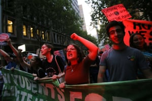 Protesters shout during a rally against climate change policy