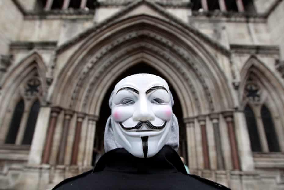 A member of Occupy London, wearing a Guy Fawkes mask, outside the High Court in London, January 18, 2012.