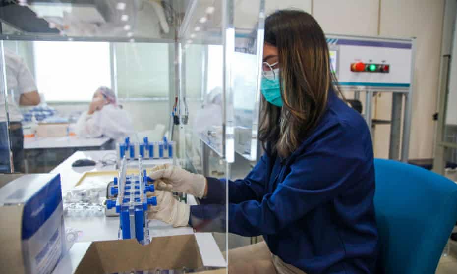 A technician works at an AutoVacc vaccine extraction machine designed by Chulalongkorn University in Bangkok to extract extra doses out of AstraZeneca vaccine vials