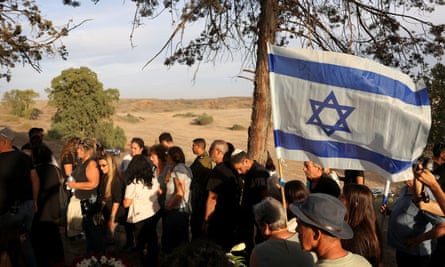 Mourners wave Israel flag