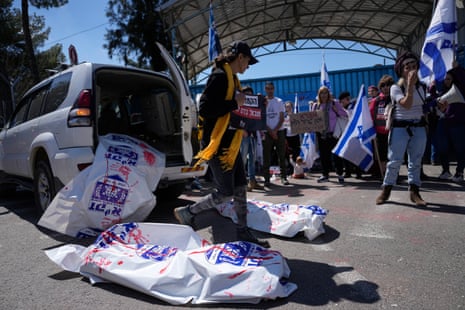 Israelis display body bags as they block the entrance to Unrwa during a protest in Jerusalem.