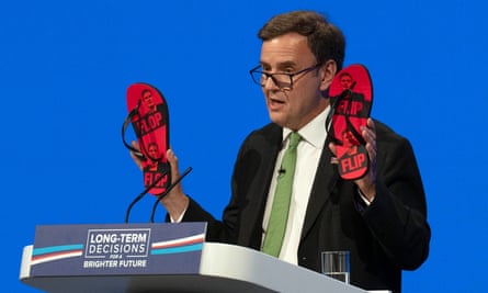 Conservative chair, Greg Hands, holds up a pair of Keir Starmer flip-flops.