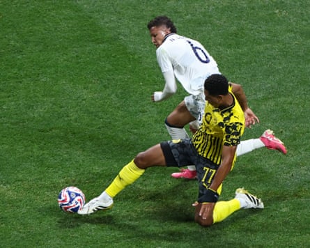 Jobe Bellingham competes for the ball with Nelson Deossa.
