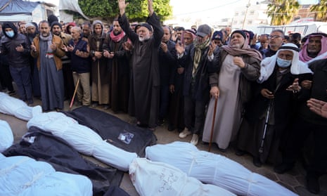 Palestinians mourn over relatives killed in the Israeli bombardments of the Gaza Strip at Al Aqsa Hospital in Deir al Balah.