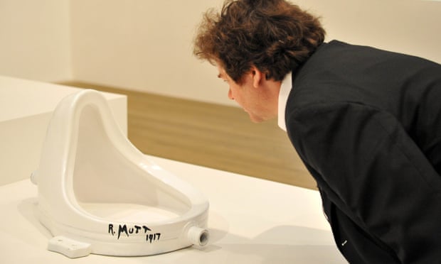 A visitor looks at Fountain (1917) by Marcel Duchamp at Tate Modern in London, 2008.