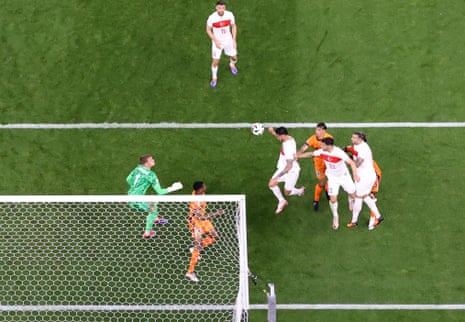 Turkey’s Samet Akaydin (centre) heads the opening goal past Netherlands goalkeeper Bart Verbruggen.