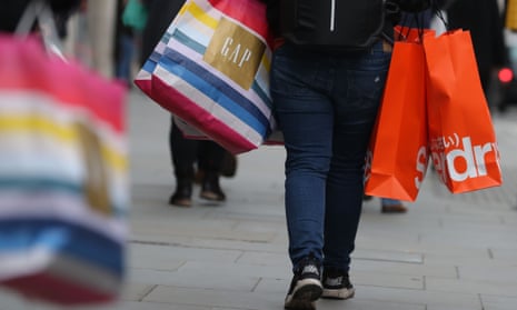 A shopper carrying bags along Oxford Street in London.