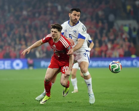 Wales' Daniel James and Bosnia's Sead Kolasinac challenge for the ball during World Cup qualifier.