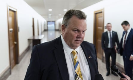 Jon Tester speaks with reporters as he arrives for a hearing on Capitol Hill.