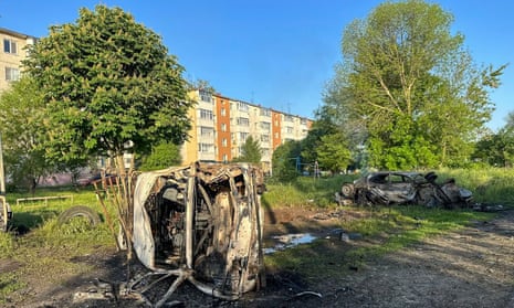 A burnt car in front of an apartment block in Shebekino.