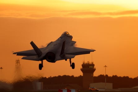 Fighter plane taking off against sunset