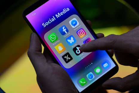 The TikTok icon is seen next to other applications on the mobile phone.