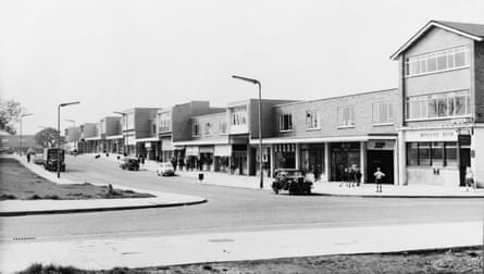 A black and white photo of 60s buildings in a town centre