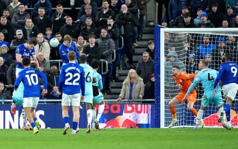 Everton’s James Tarkowski (left( heads home to open the scoring against Burnley.