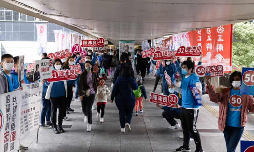 people holding campaign signs