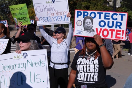 people hold signs in support of voting rights