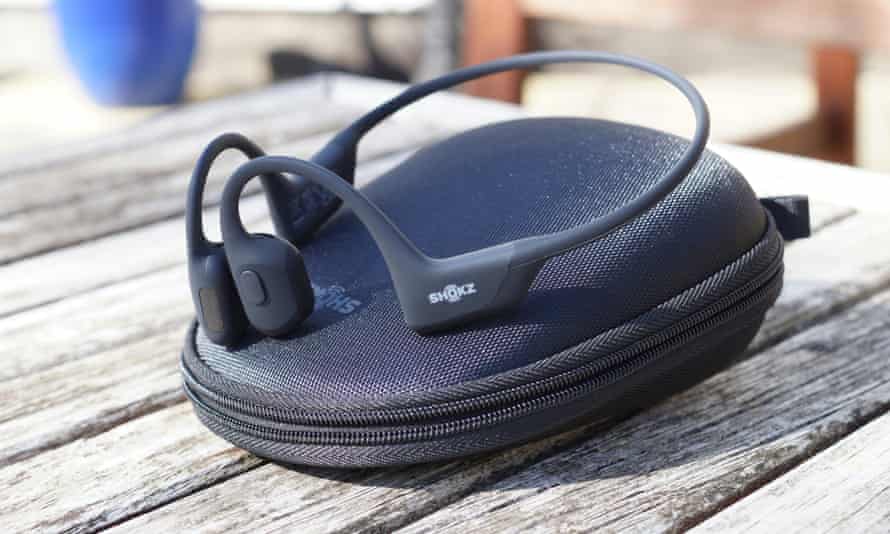 A pair of Shokz OpenRun Pro headphones sitting on their nylon case.
