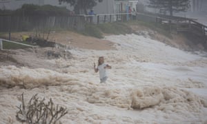 A woman is swamped by a wave on Sydney's northern beaches