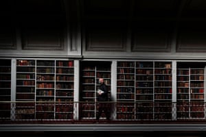 Man with books in front of bookshelves